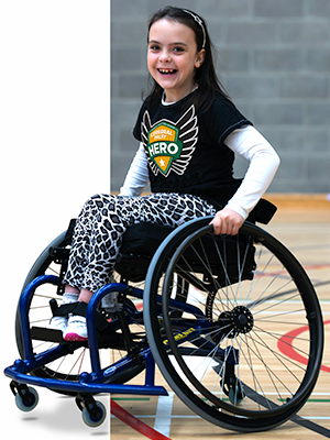 Young girl with cerebral palsy in wheelchair on basketball court