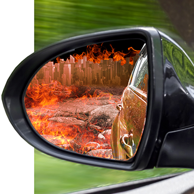 Car from driver POV looking into mirror to see flame-filled area behind