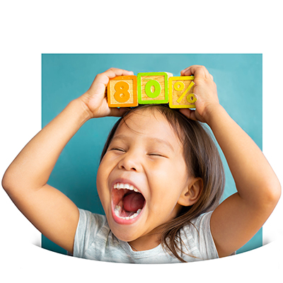 Excited young girl yelling and holding wooden blocks over her head