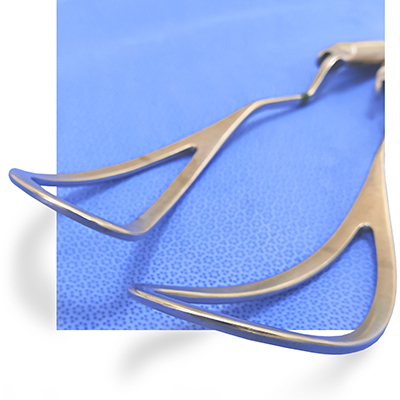 set of delivery forceps on a blue patterned background