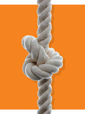 knotted white rope or cord on an orange background
